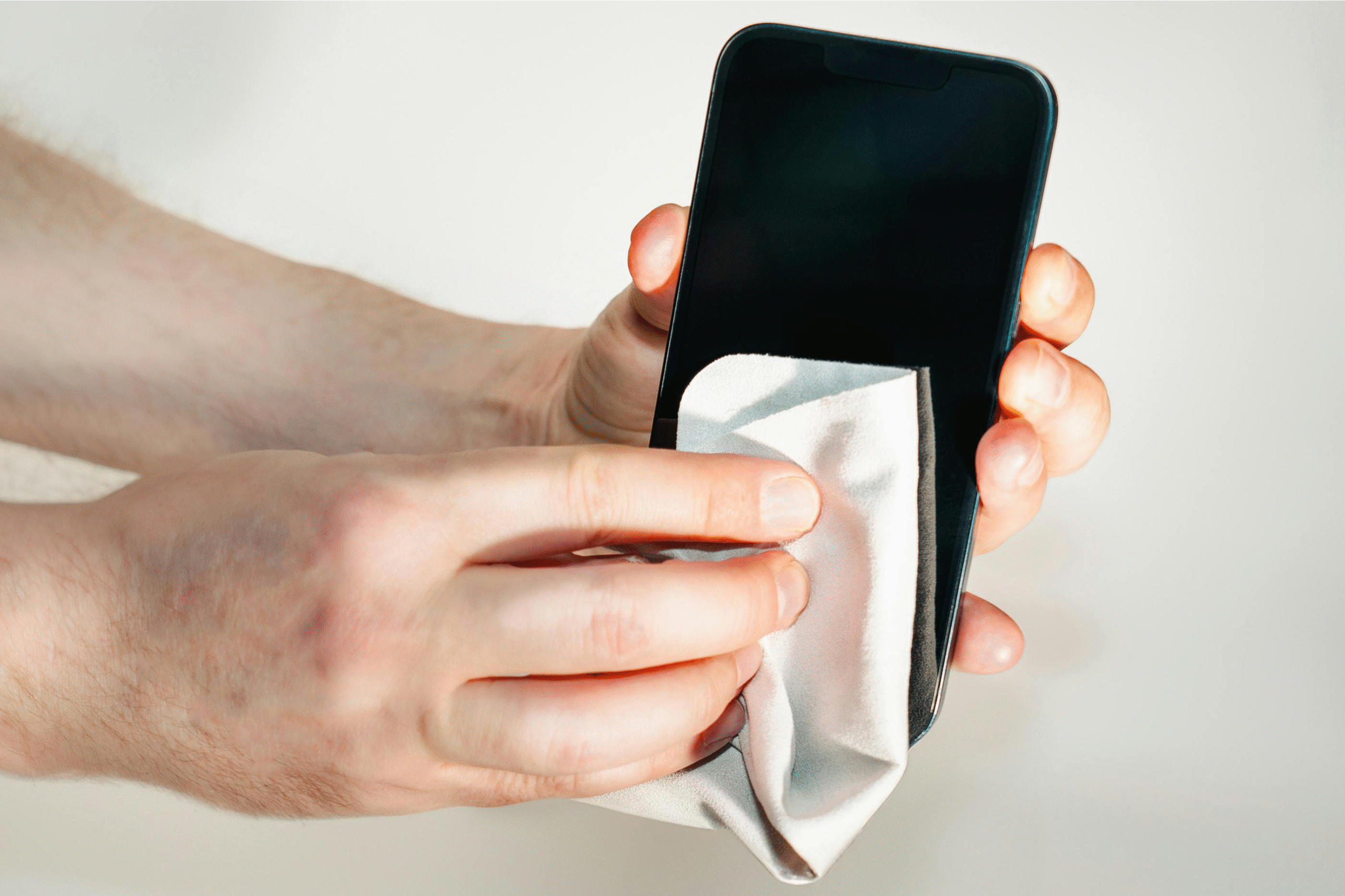cleaning phone screen with microfiber cloth