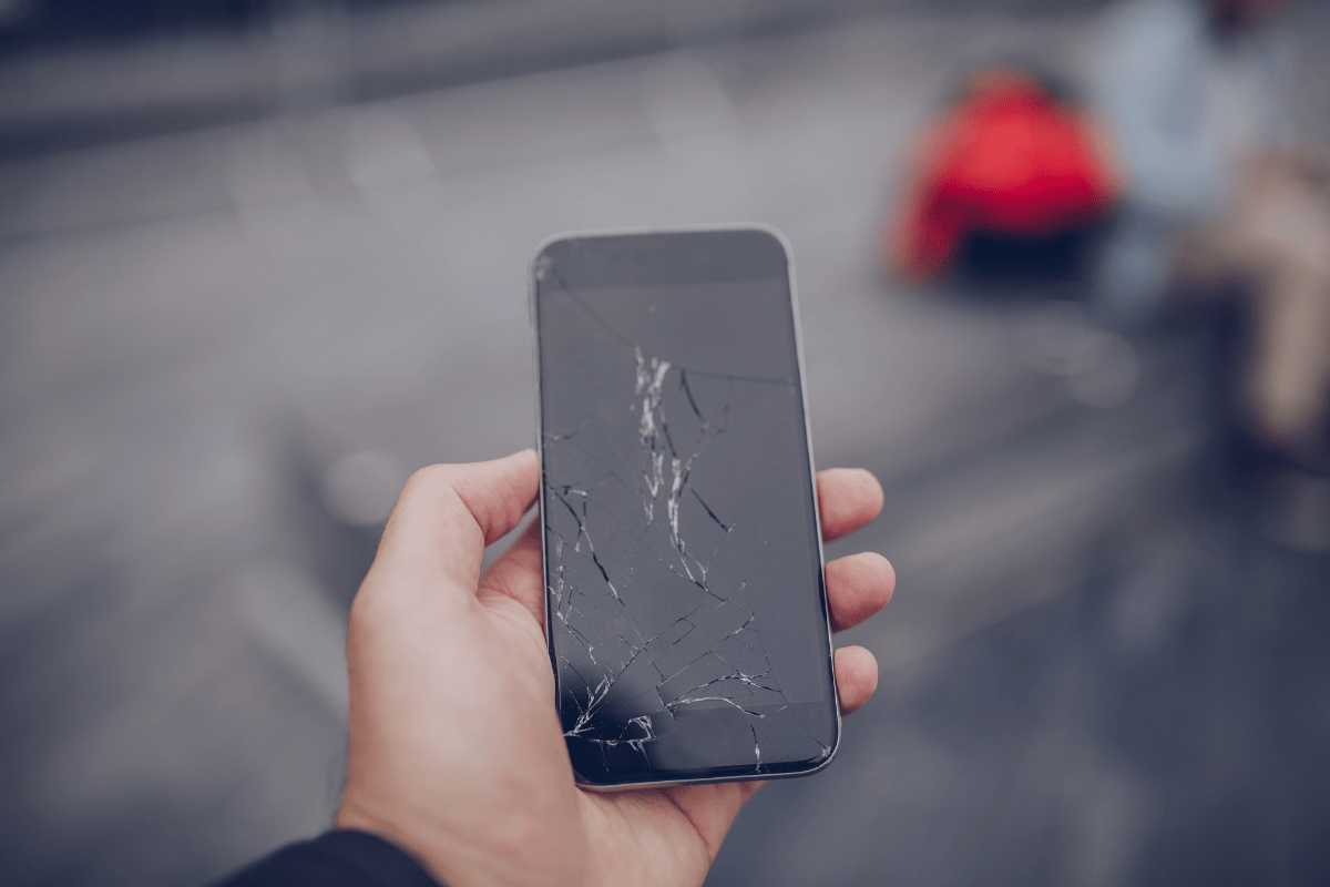 hand holding cracked iphone
