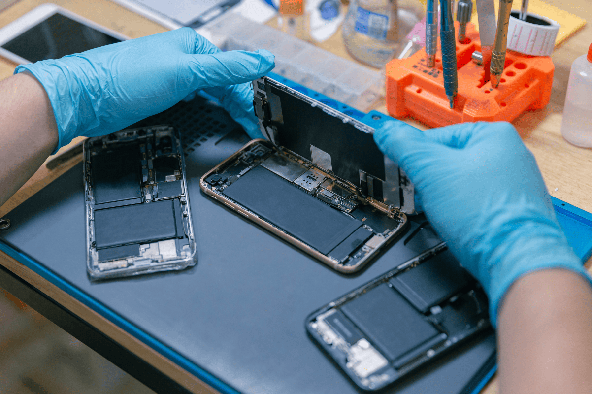 Mobile phone technician repairing smartphone